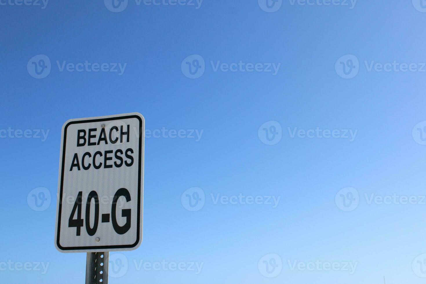 Beach sign blue sky with clouds photo