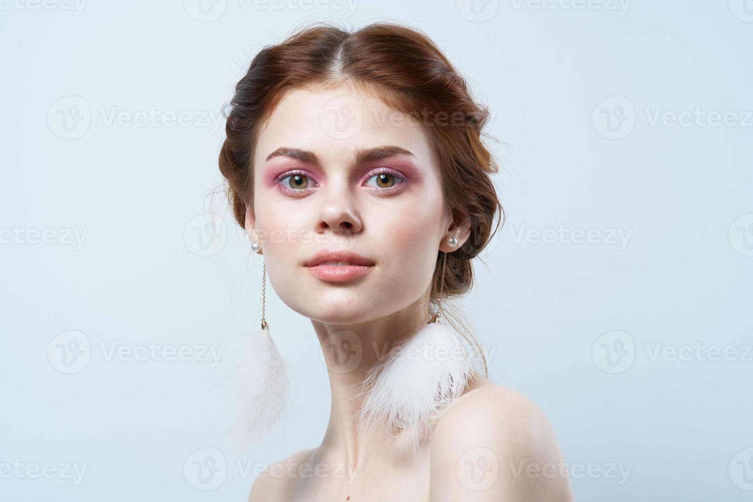 attractive woman bare shoulders fluffy earrings cosmetics close-up photo
