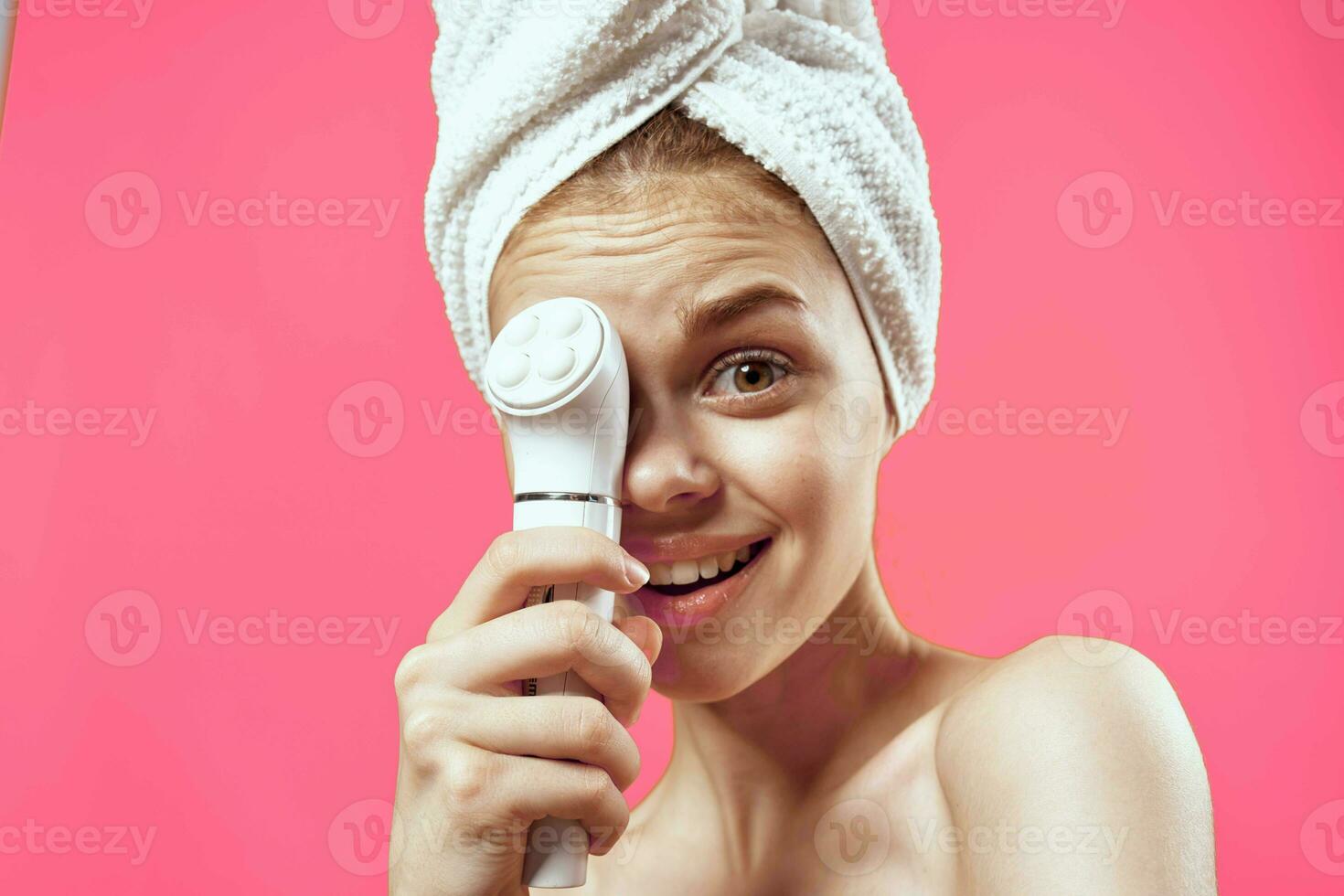 emotional woman with bare shoulders cleansing face dermatology procedure photo