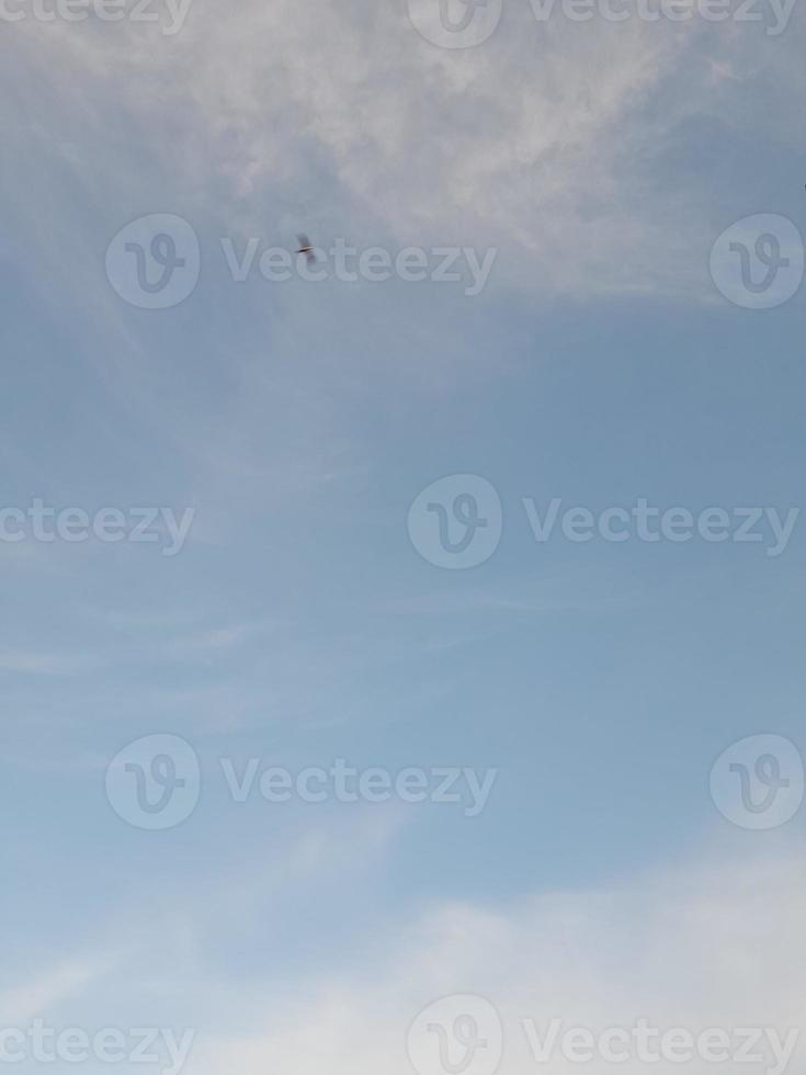 Beautiful white clouds on deep blue sky background. Large bright soft fluffy clouds are cover the entire blue sky. photo