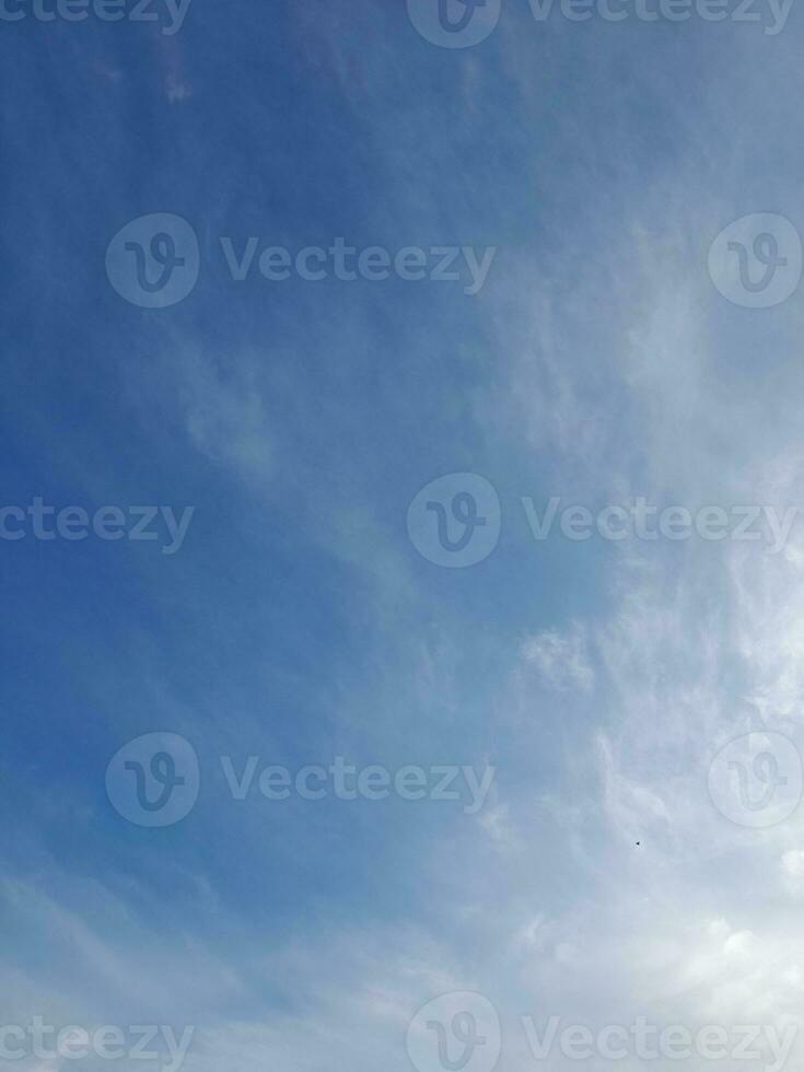 Beautiful white clouds on deep blue sky background. Large bright soft fluffy clouds are cover the entire blue sky. photo