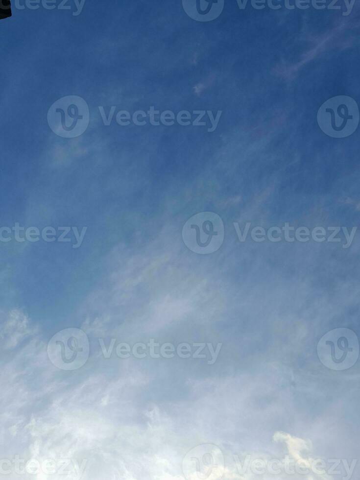Beautiful white clouds on deep blue sky background. Large bright soft fluffy clouds are cover the entire blue sky. photo
