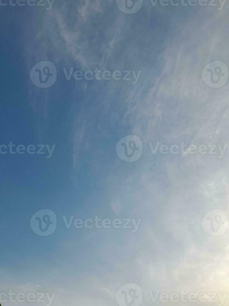 Beautiful white clouds on deep blue sky background. Large bright soft fluffy clouds are cover the entire blue sky. photo