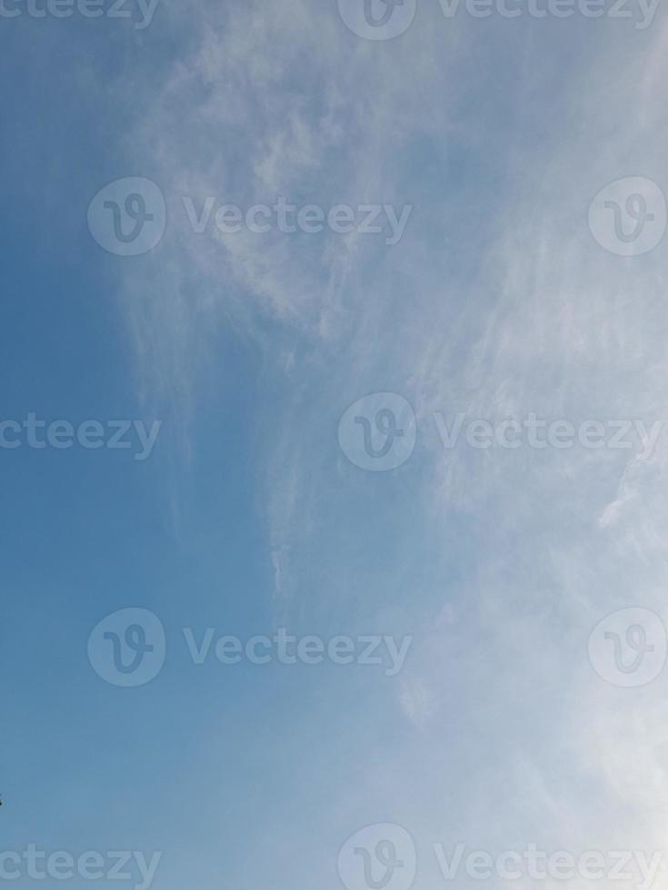 Beautiful white clouds on deep blue sky background. Large bright soft fluffy clouds are cover the entire blue sky. photo