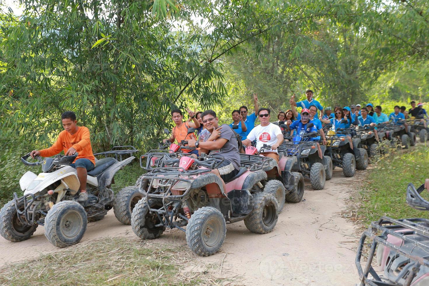 NAKHONNAYOK, THAILAND - DECEMBER 19 Tourists riding ATV to nature adventure on dirt track on DECEMBER 19, 2015, Thailand. photo