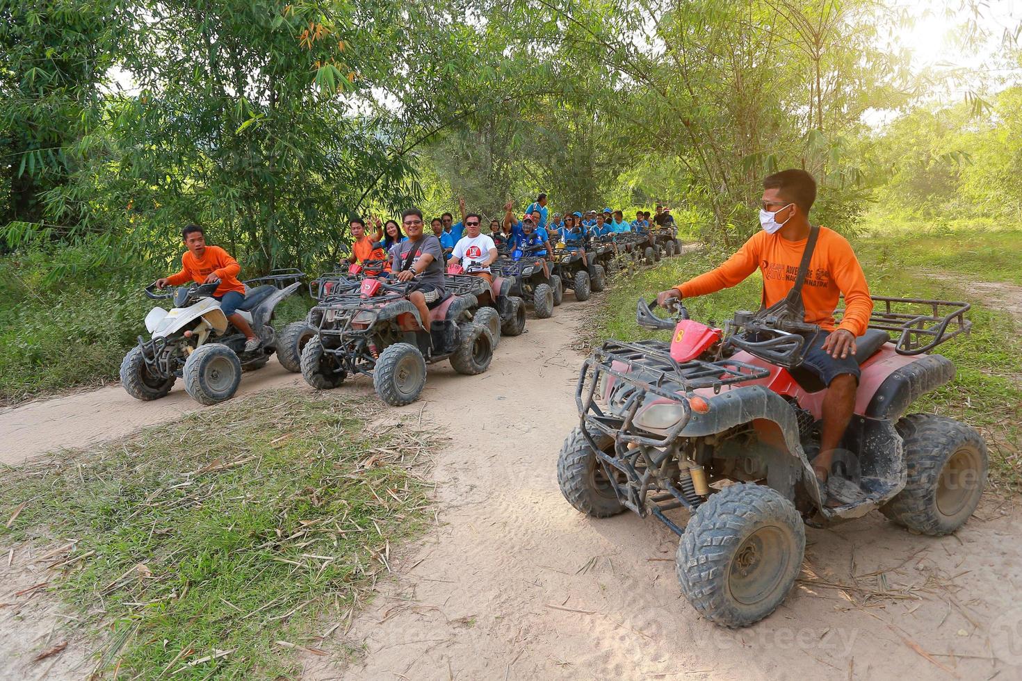 NAKHONNAYOK, THAILAND - DECEMBER 19 Tourists riding ATV to nature adventure on dirt track on DECEMBER 19, 2015, Thailand. photo