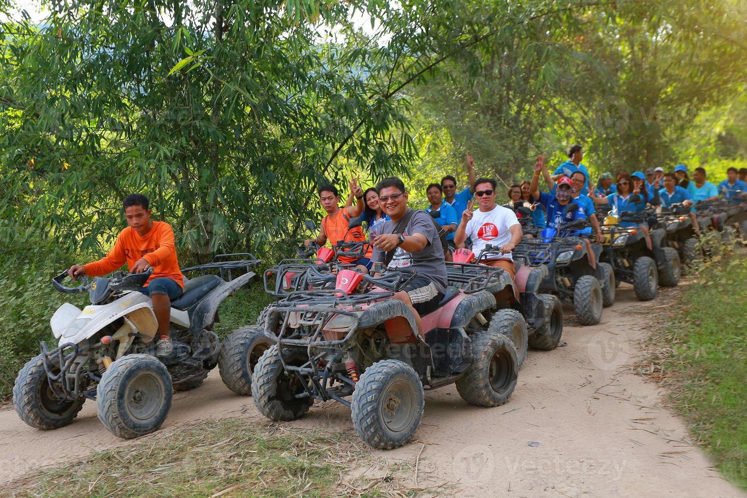 NAKHONNAYOK, THAILAND - DECEMBER 19 Tourists riding ATV to nature adventure on dirt track on DECEMBER 19, 2015, Thailand. photo