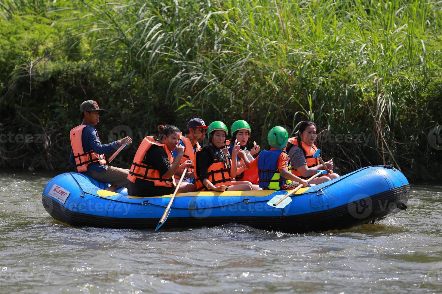 NAKHONNAYOK, THAILAND,DECEMBER 19  Group of adventurer doing white water rafting at dam, on December 19, 2015,The river is popular for its scenic nature view. photo