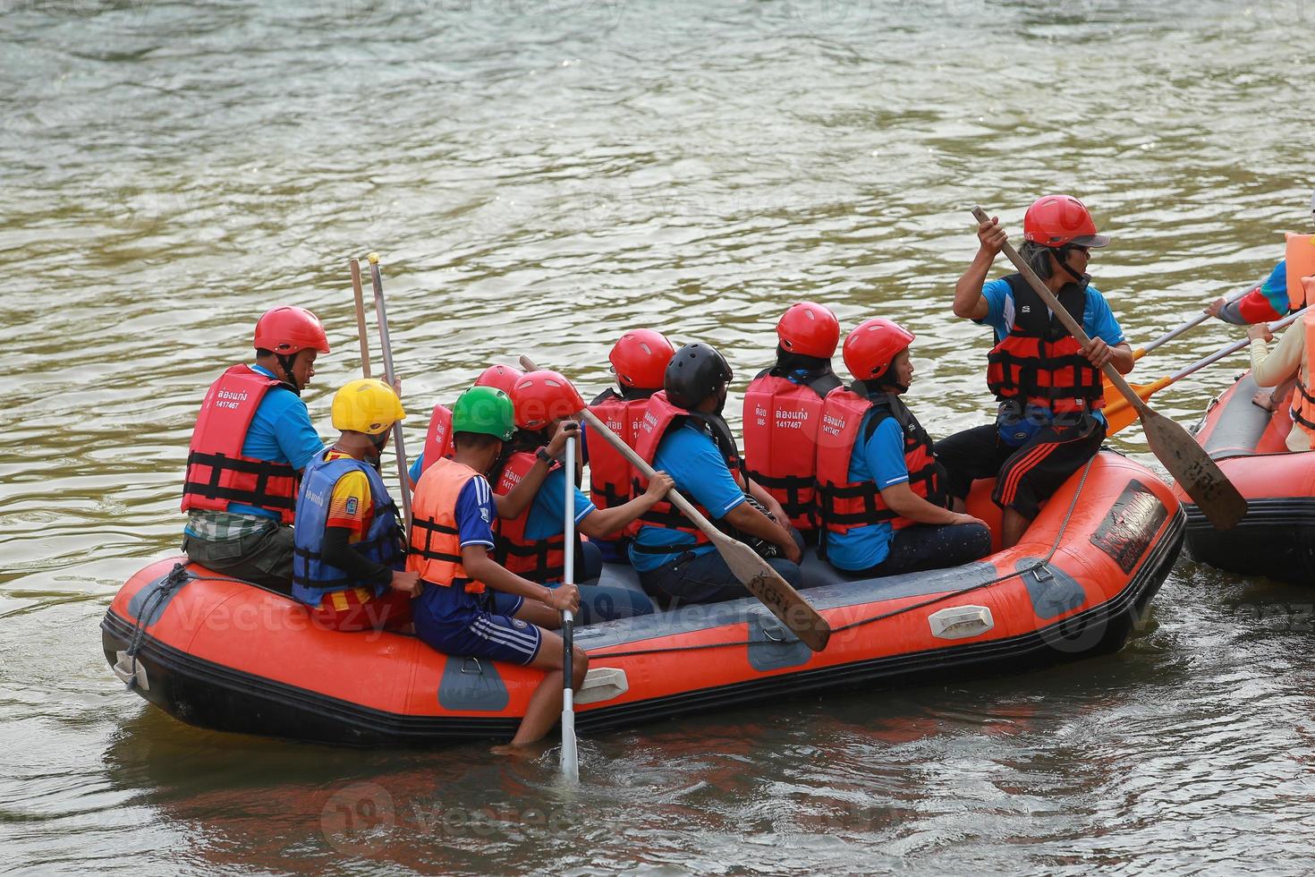 NAKHONNAYOK, THAILAND,DECEMBER 19  Group of adventurer doing white water rafting at dam, on December 19, 2015,The river is popular for its scenic nature view. photo