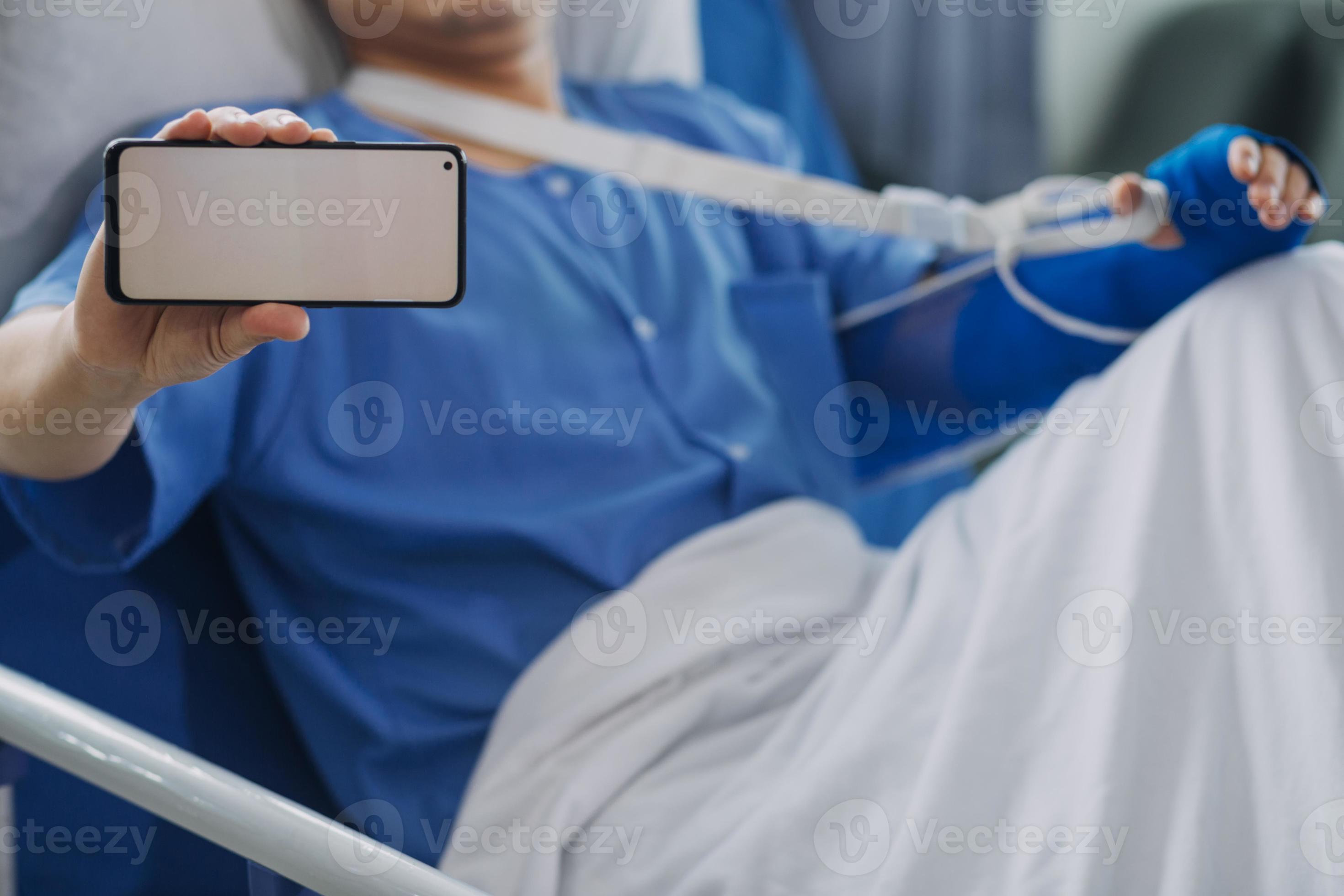 Injured patient showing doctor broken wrist and arm with bandage in