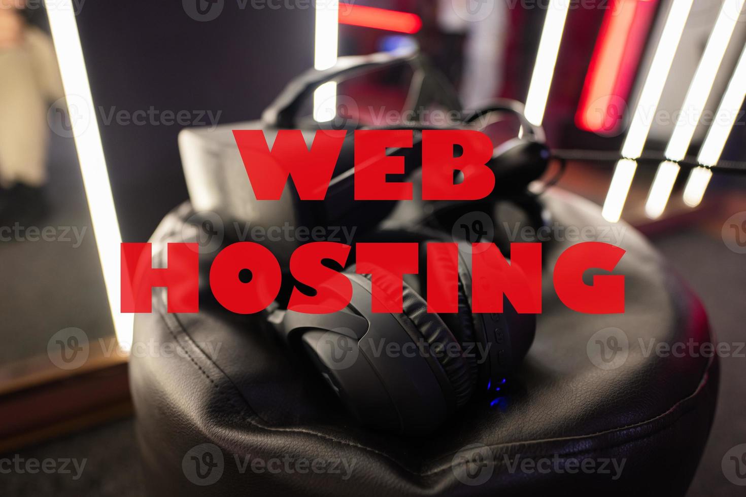 Web hosting concept. Professional headphones with microphone and vr glasses for video games and cyber sports on background. photo