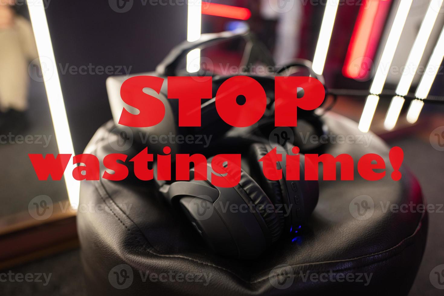 Stop wasting time concept. Professional headphones with microphone and vr glasses for video games and cyber sports on background. photo