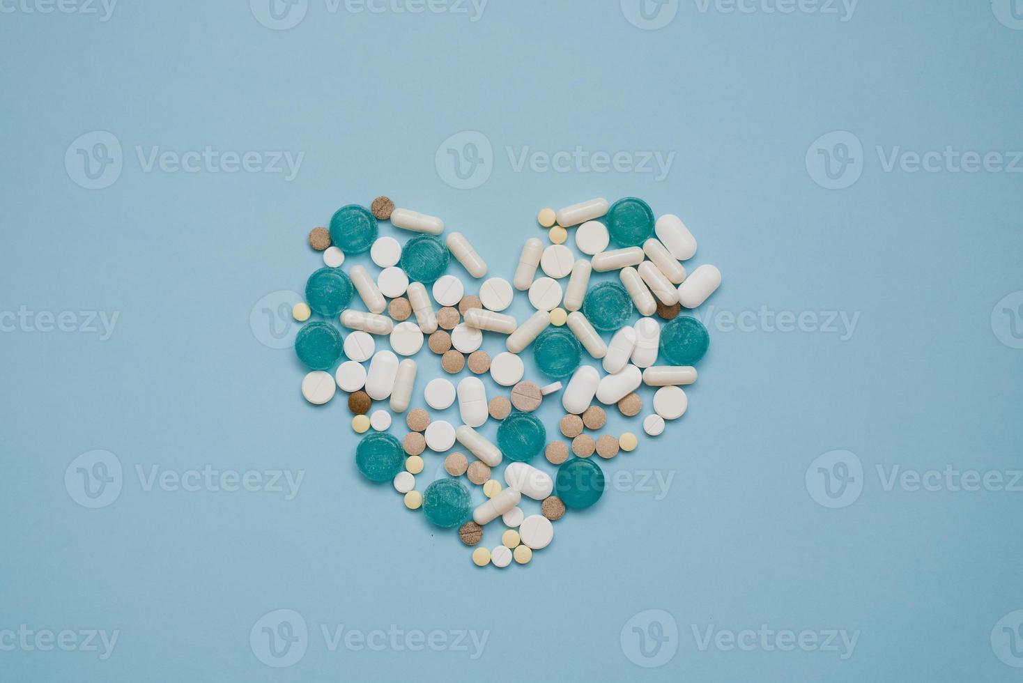 Heart symbol in the format of various tablets highlighted on a blue background. view from above. The concept of cardiology and health photo