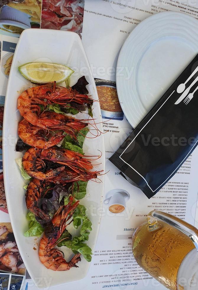 spanish grilled tiger prawns on a plate in a restaurant photo