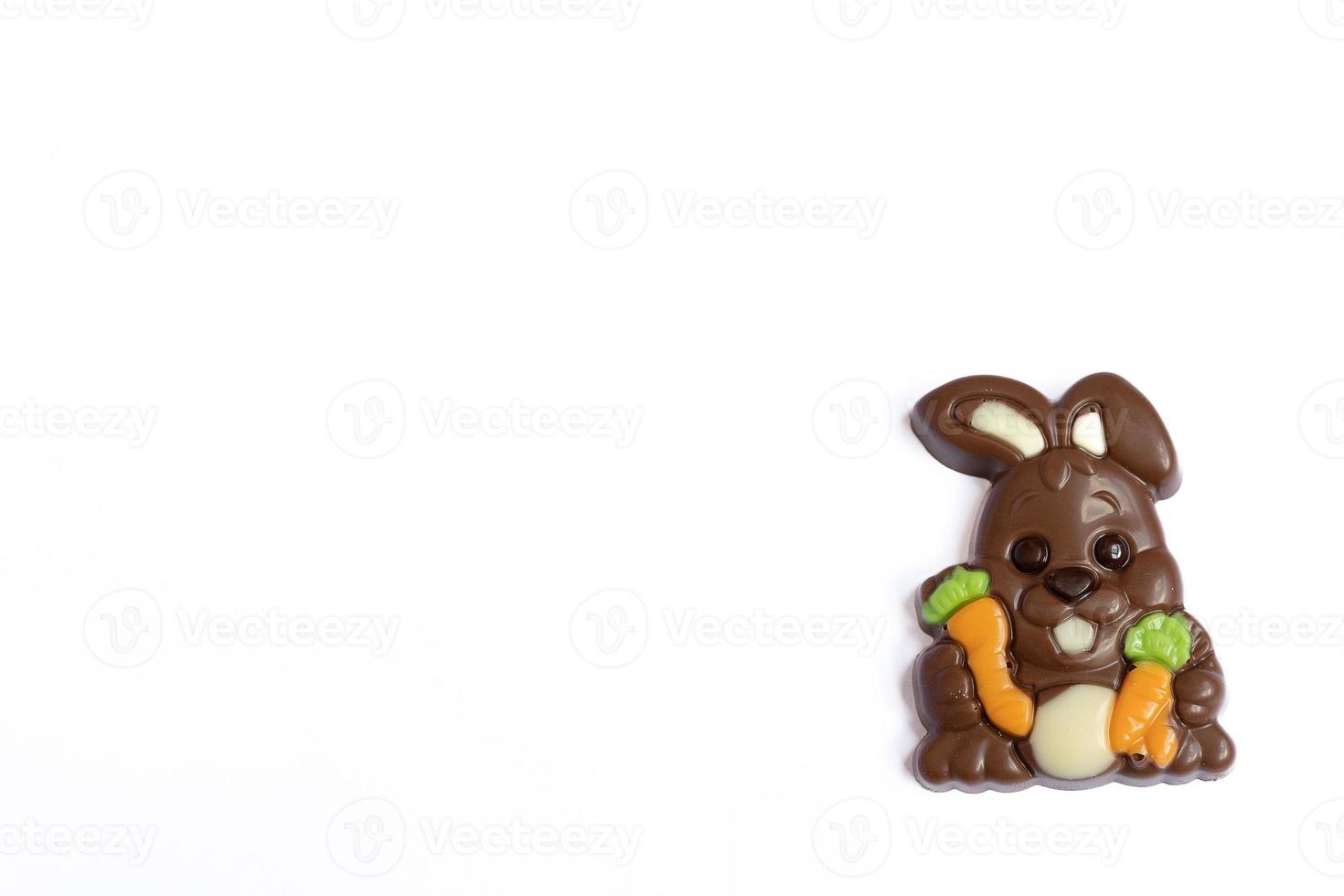 sweet rabbit-shaped chocolate for easter on a light background photo