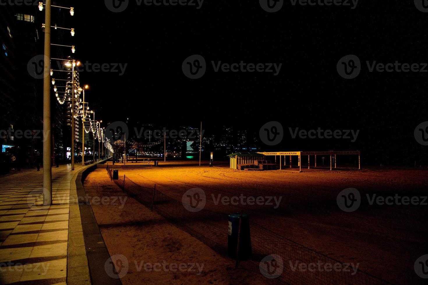 seaside beach landscape with promenade at night in Benidorm, Spain photo