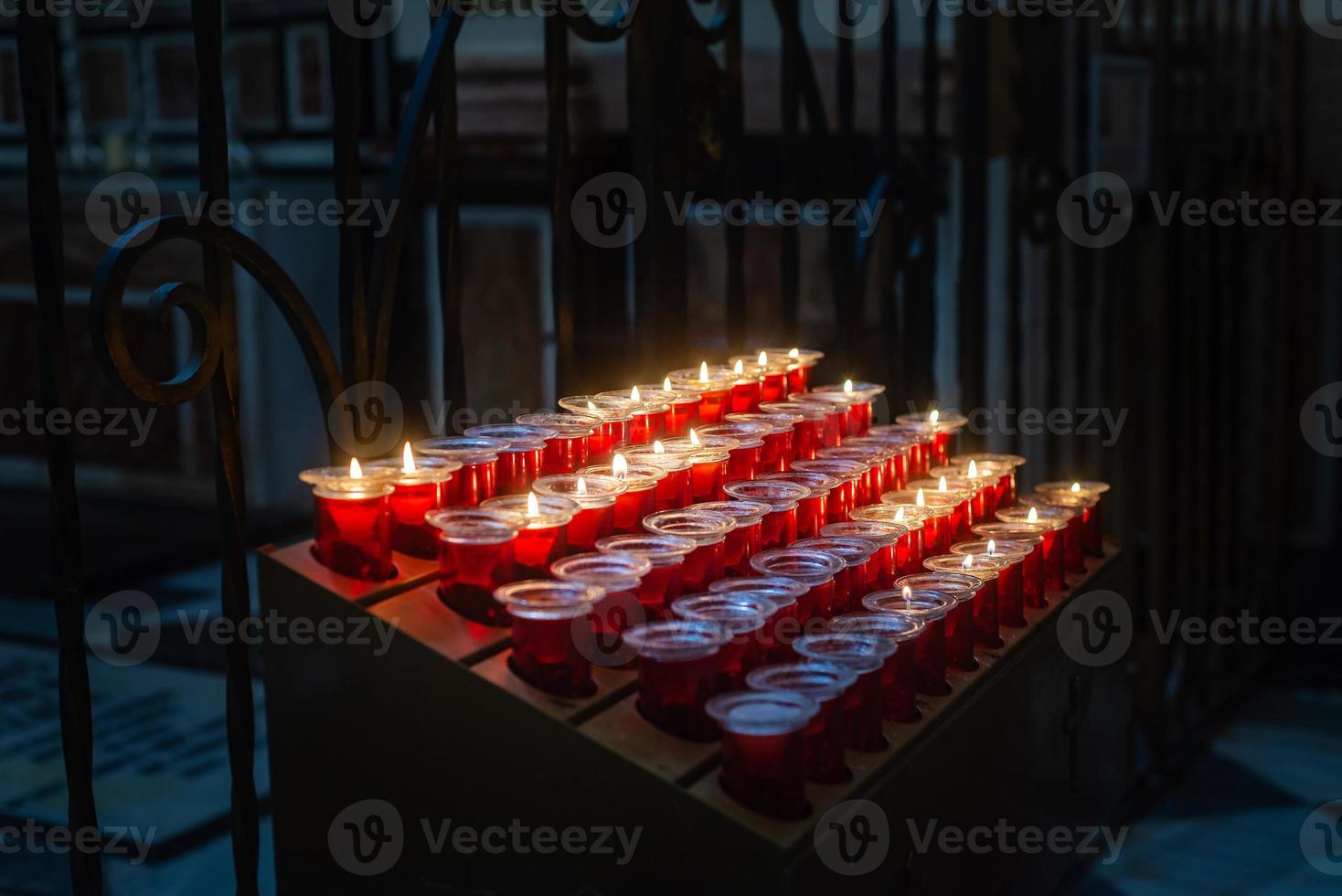 Candles on a stand inside a catholic church photo