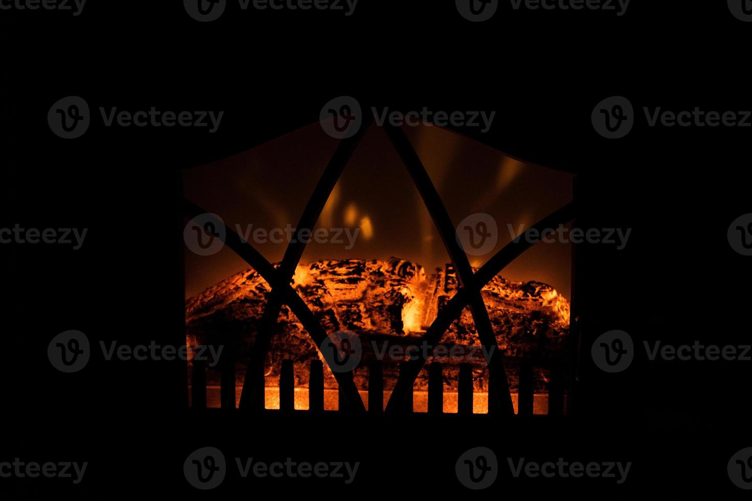 winter black background with fireplace and red hot blazing fire photo