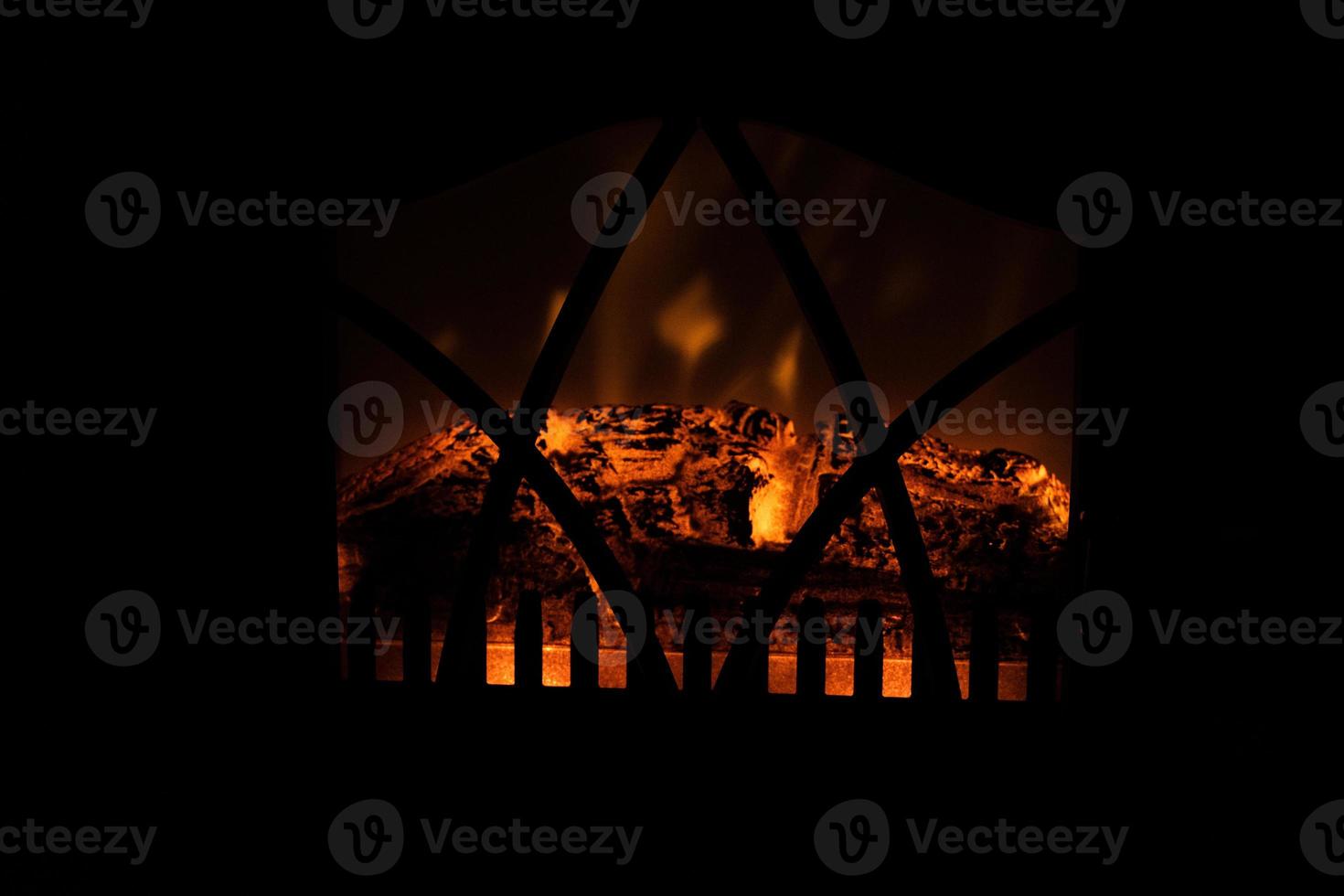 winter black background with fireplace and red hot blazing fire photo