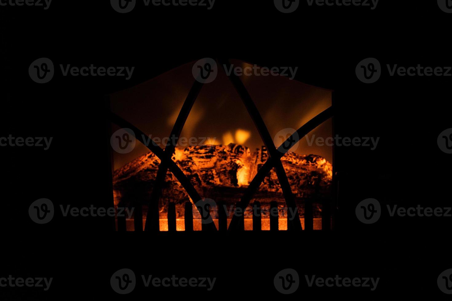 winter black background with fireplace and red hot blazing fire photo