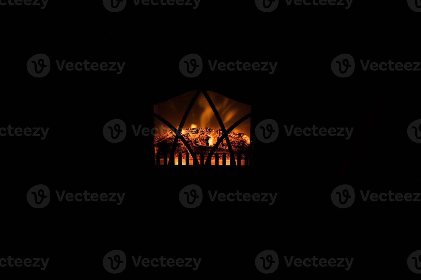winter black background with fireplace and red hot blazing fire photo