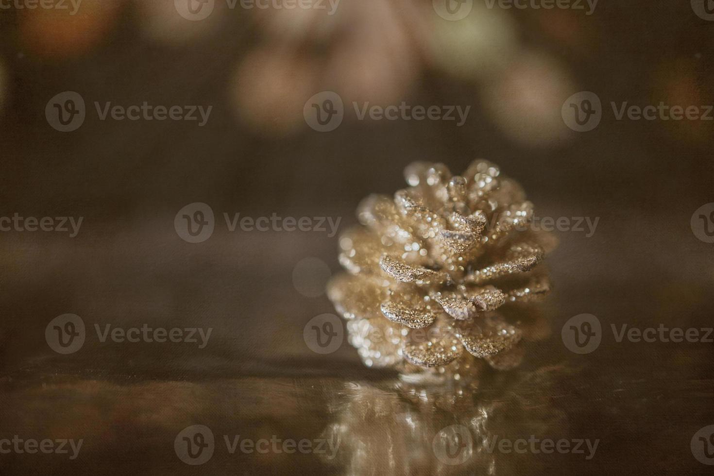 golden christmas cone on the background of bokeh in closeup photo