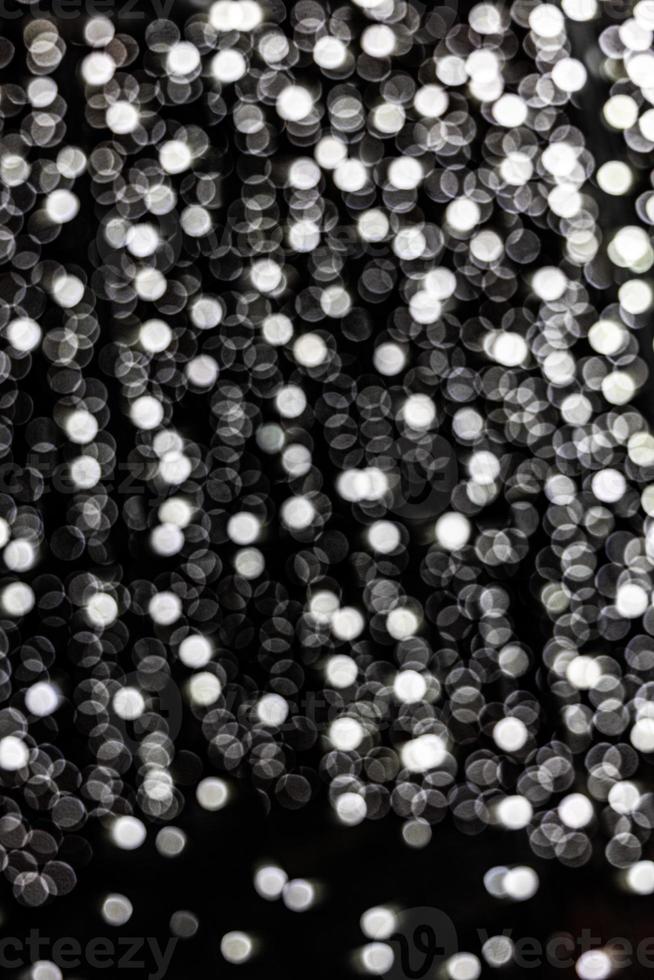silver festive background with bokeh on black background photo