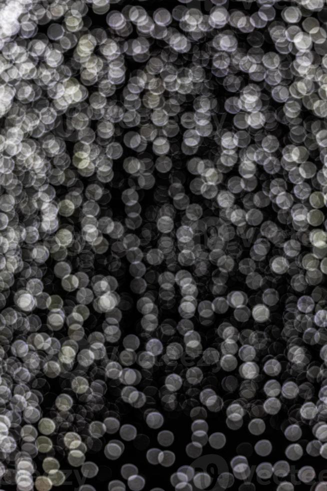 silver festive background with bokeh on black background photo