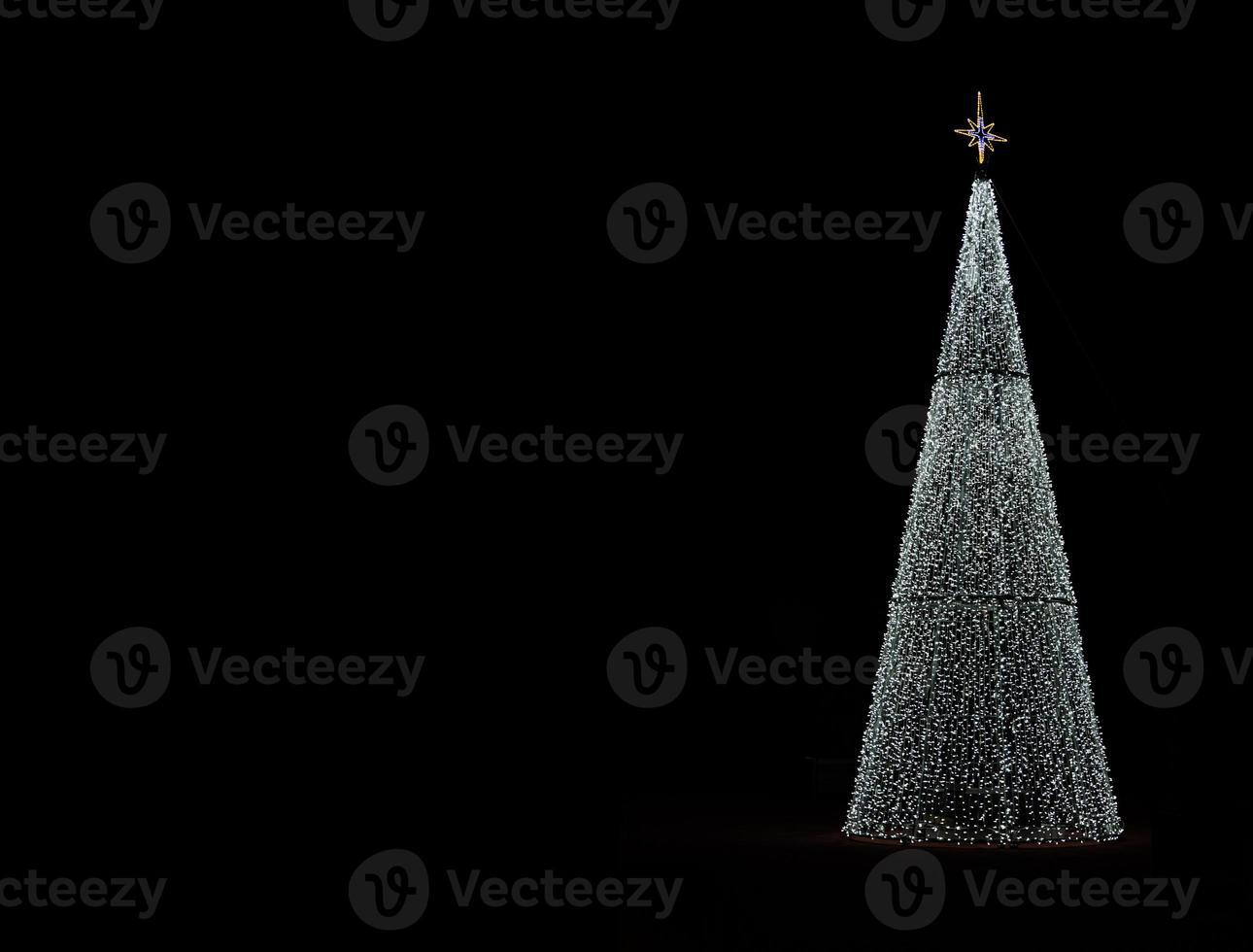 glowing christmas tree decoration on black background photo