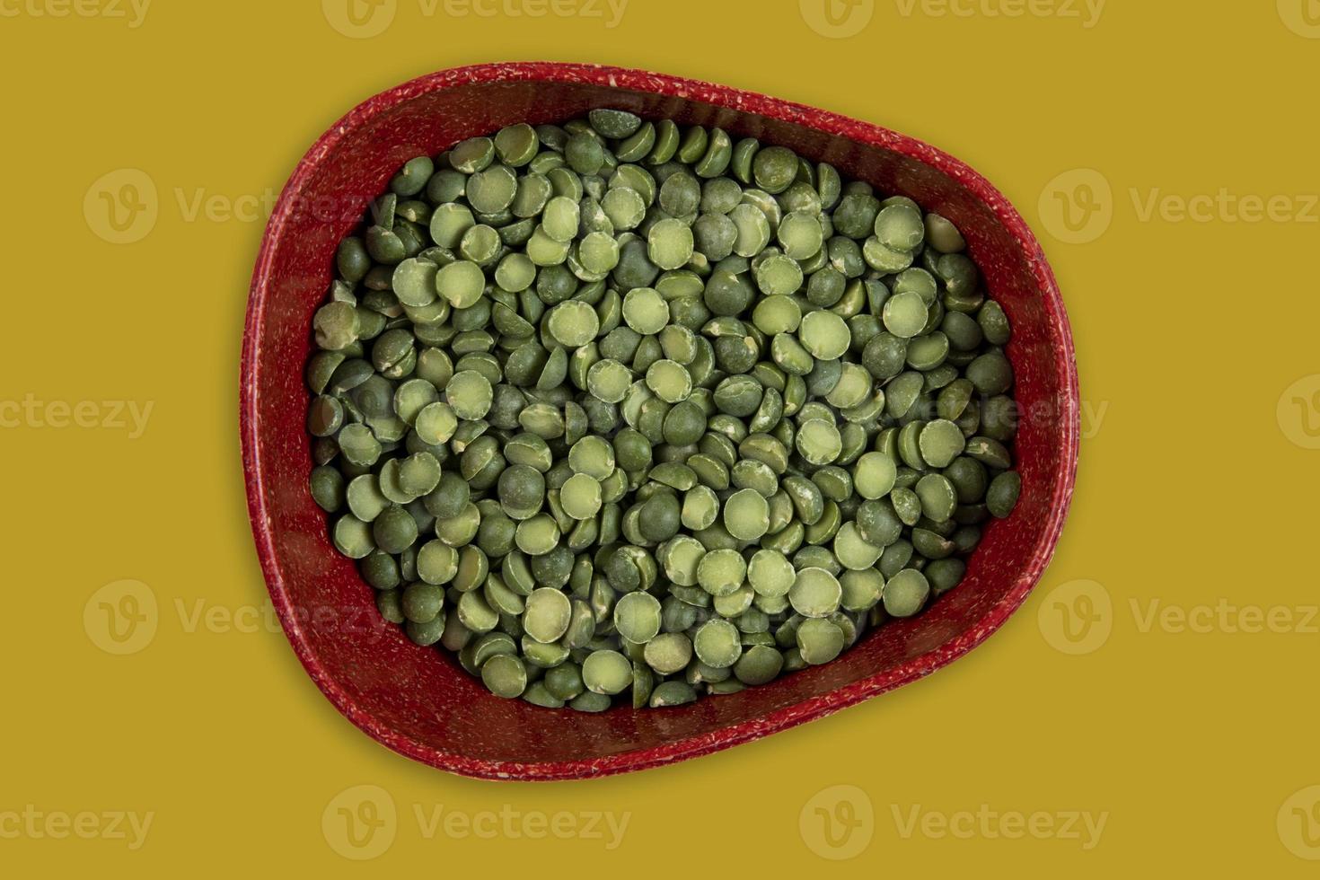 green peas in halves in bowl isolated on background. Top view. Flat lay photo