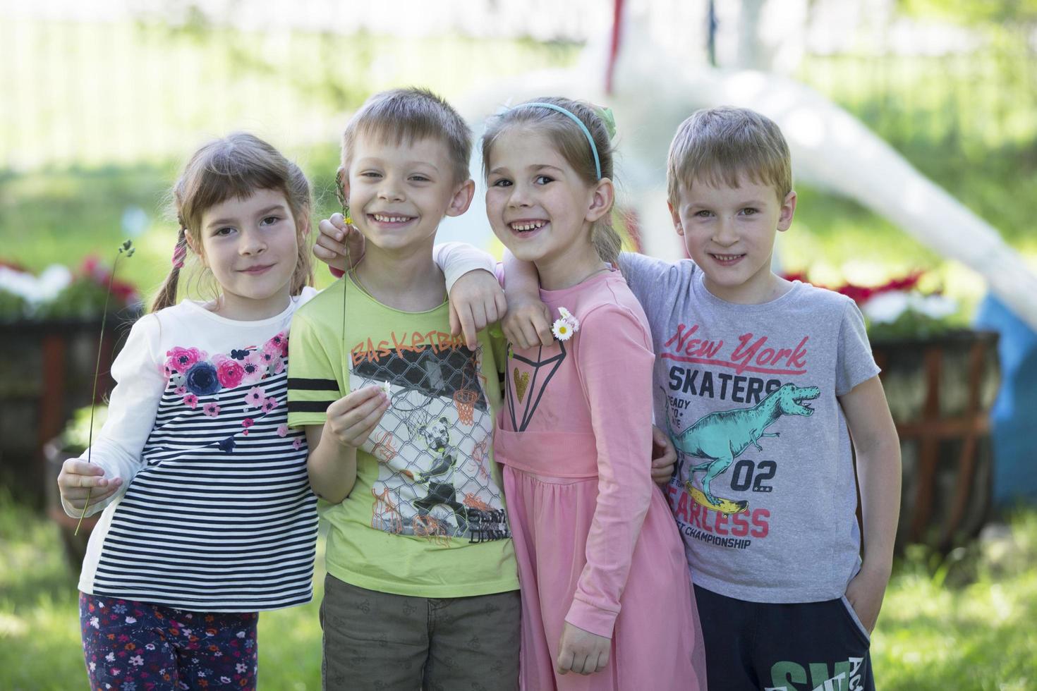 Cheerful children from kindergarten on a summer walk. photo