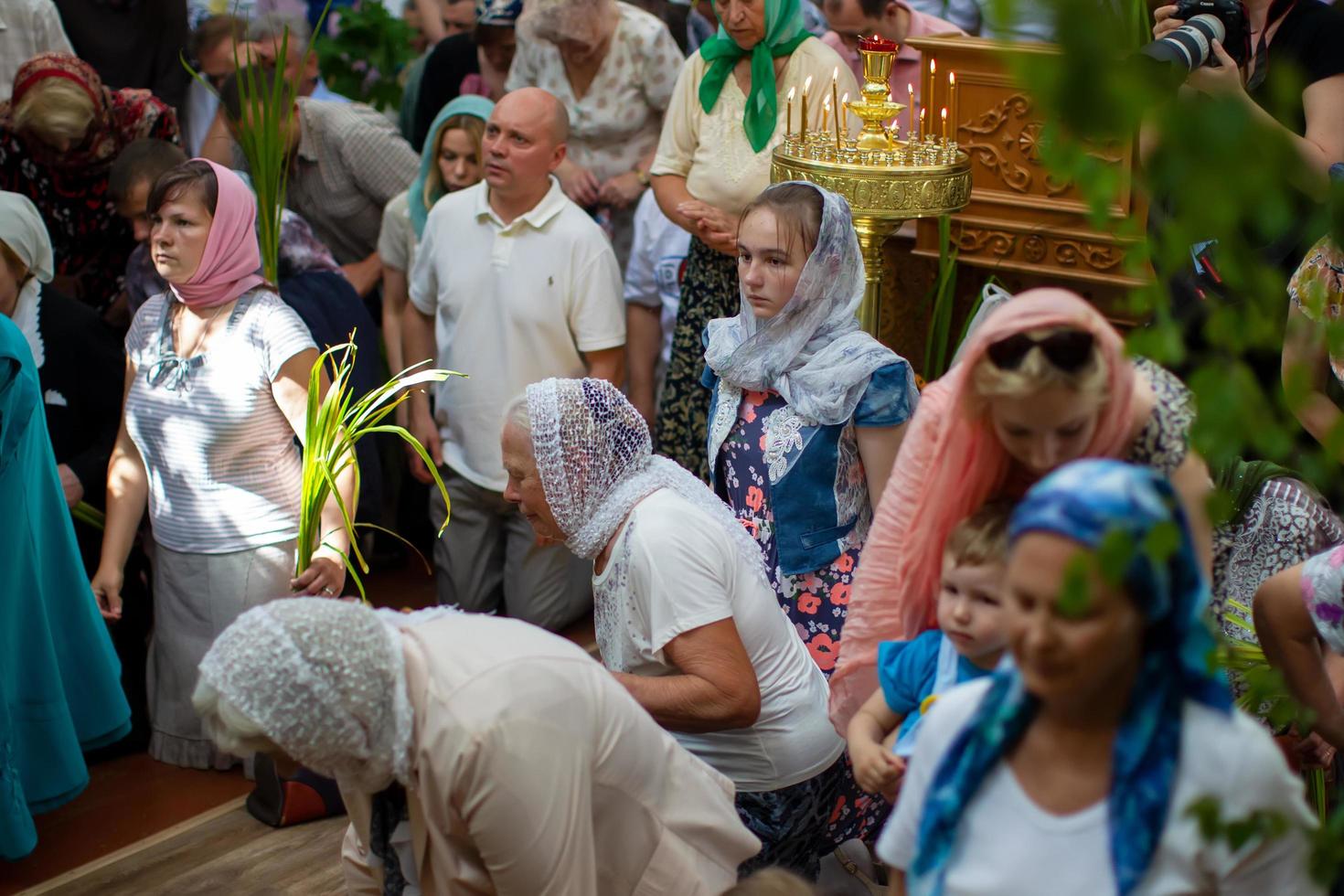Many people in the temple celebrate Palm Sunday. Orthodox believers. A crowd of residents in the church. photo