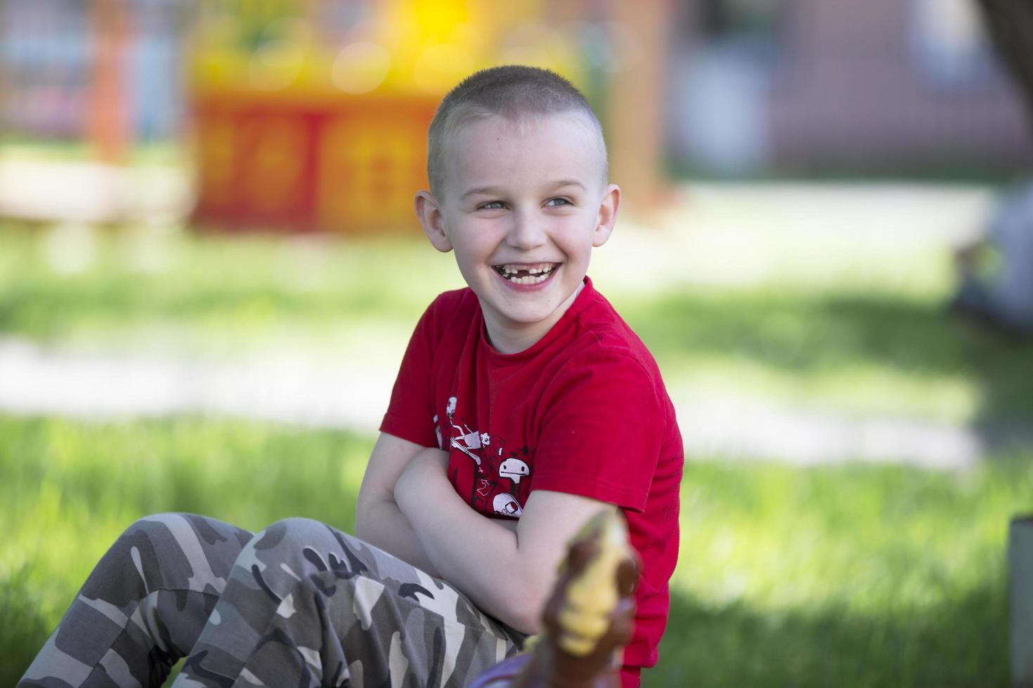 Cheerful boy preschoolers play on a summer street. Six year old child. photo