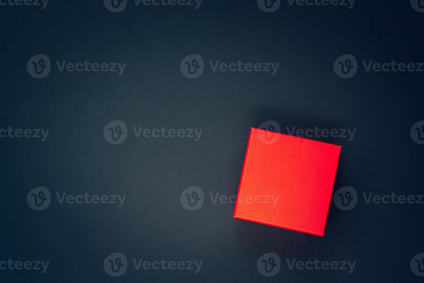 Flat lay. Red box on a dark blue background for a template with a logo or title. Layout for the brand. Vignetting. Copy space. photo