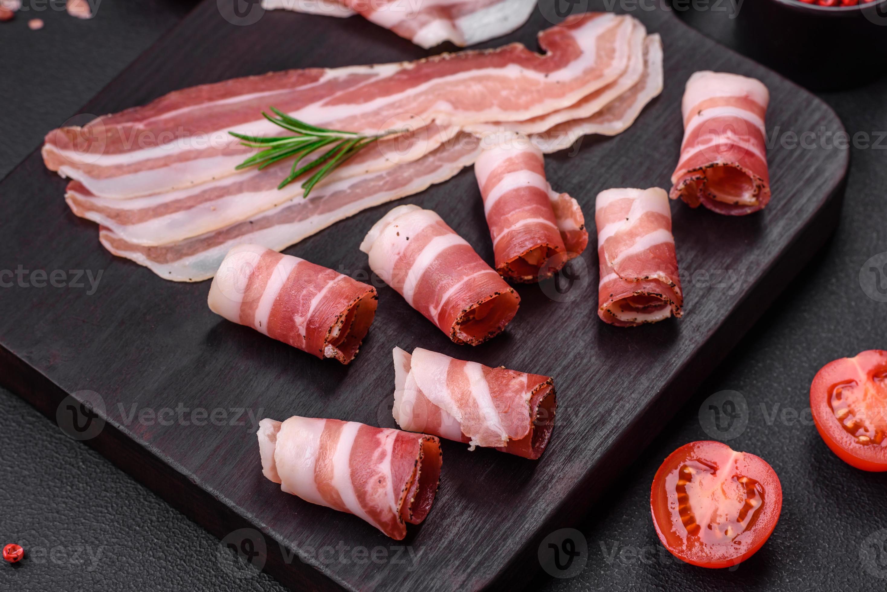 Delicious fresh pancetta with salt and spices cut into thin slices