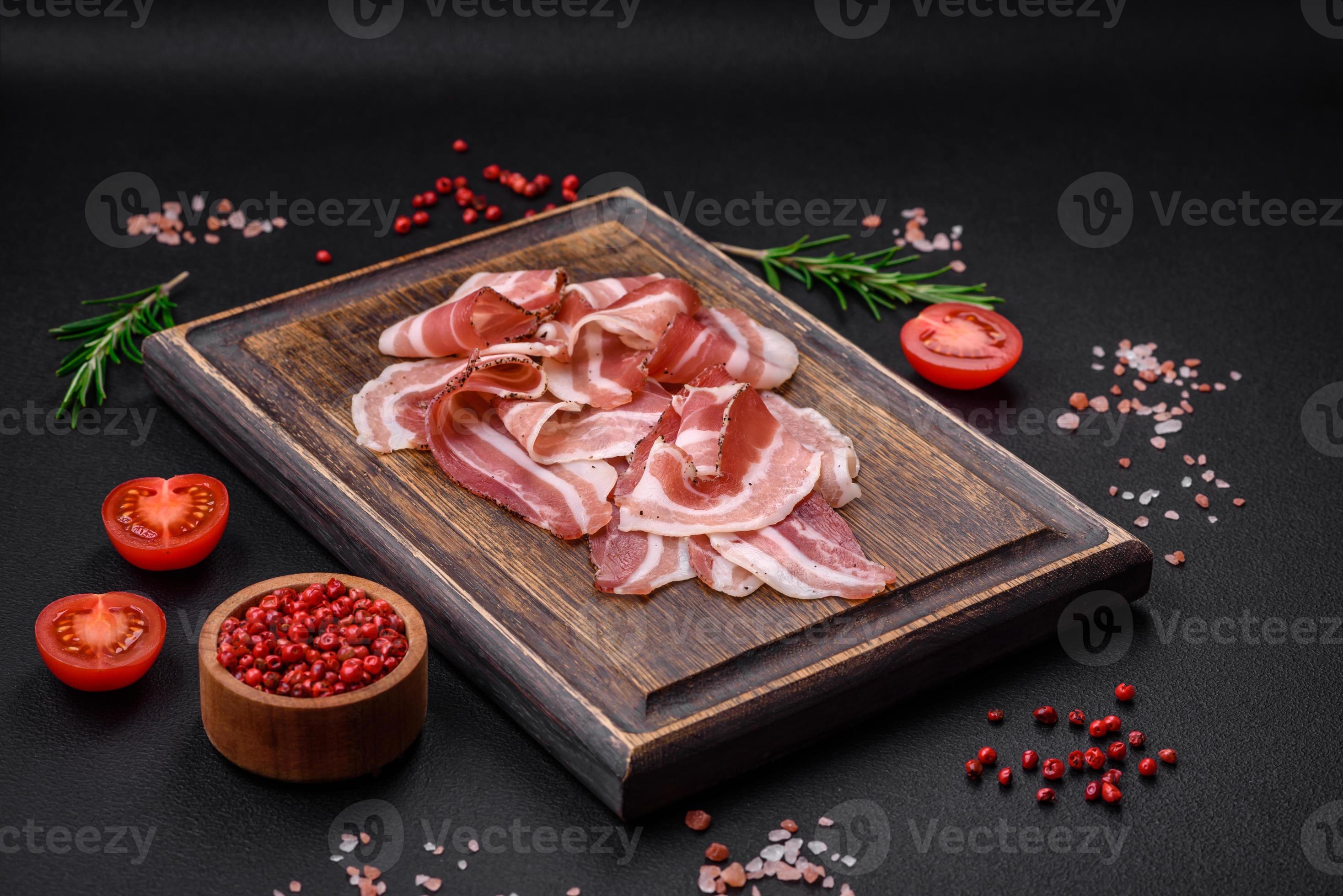 Delicious fresh pancetta with salt and spices cut into thin slices