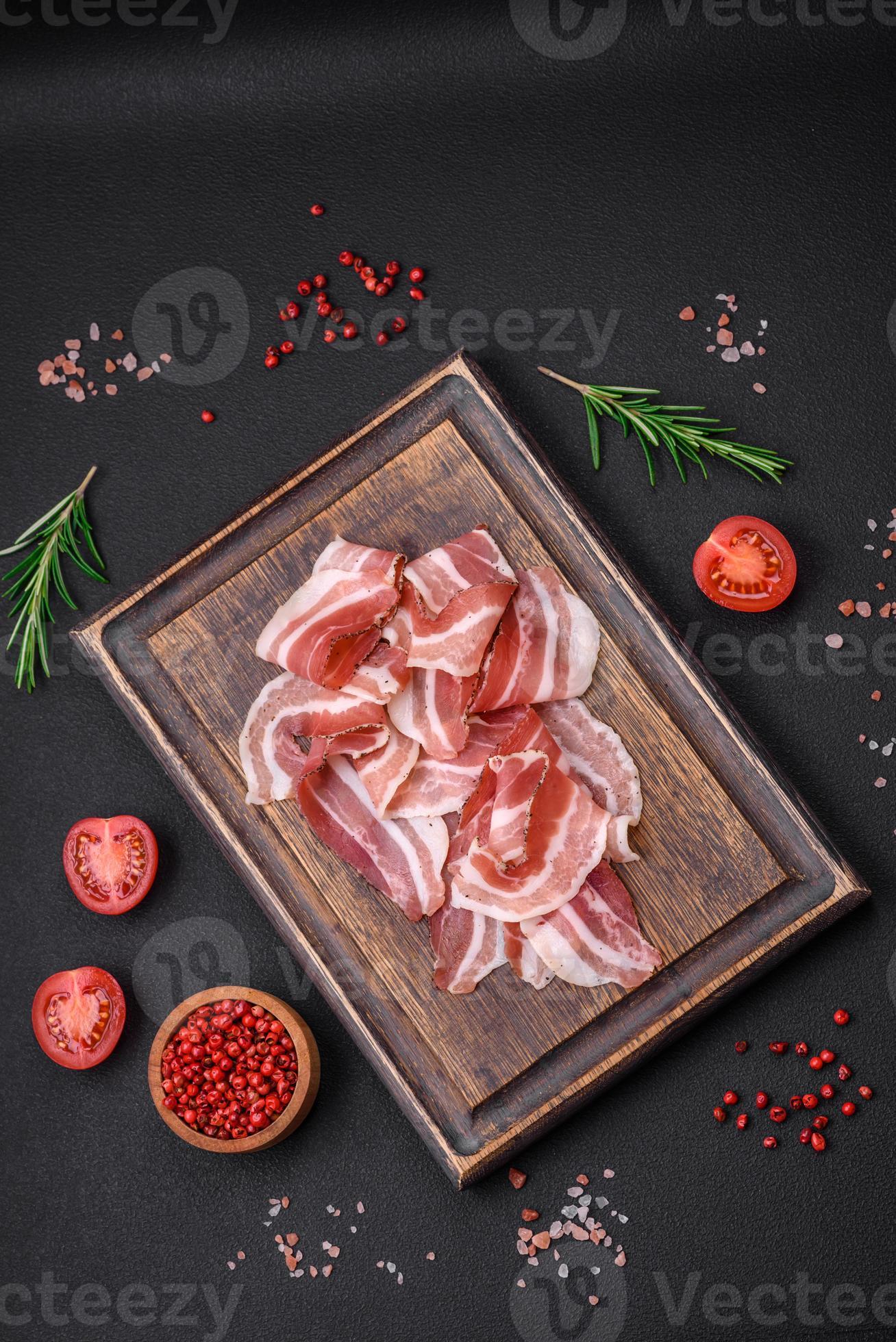 Delicious fresh pancetta with salt and spices cut into thin slices