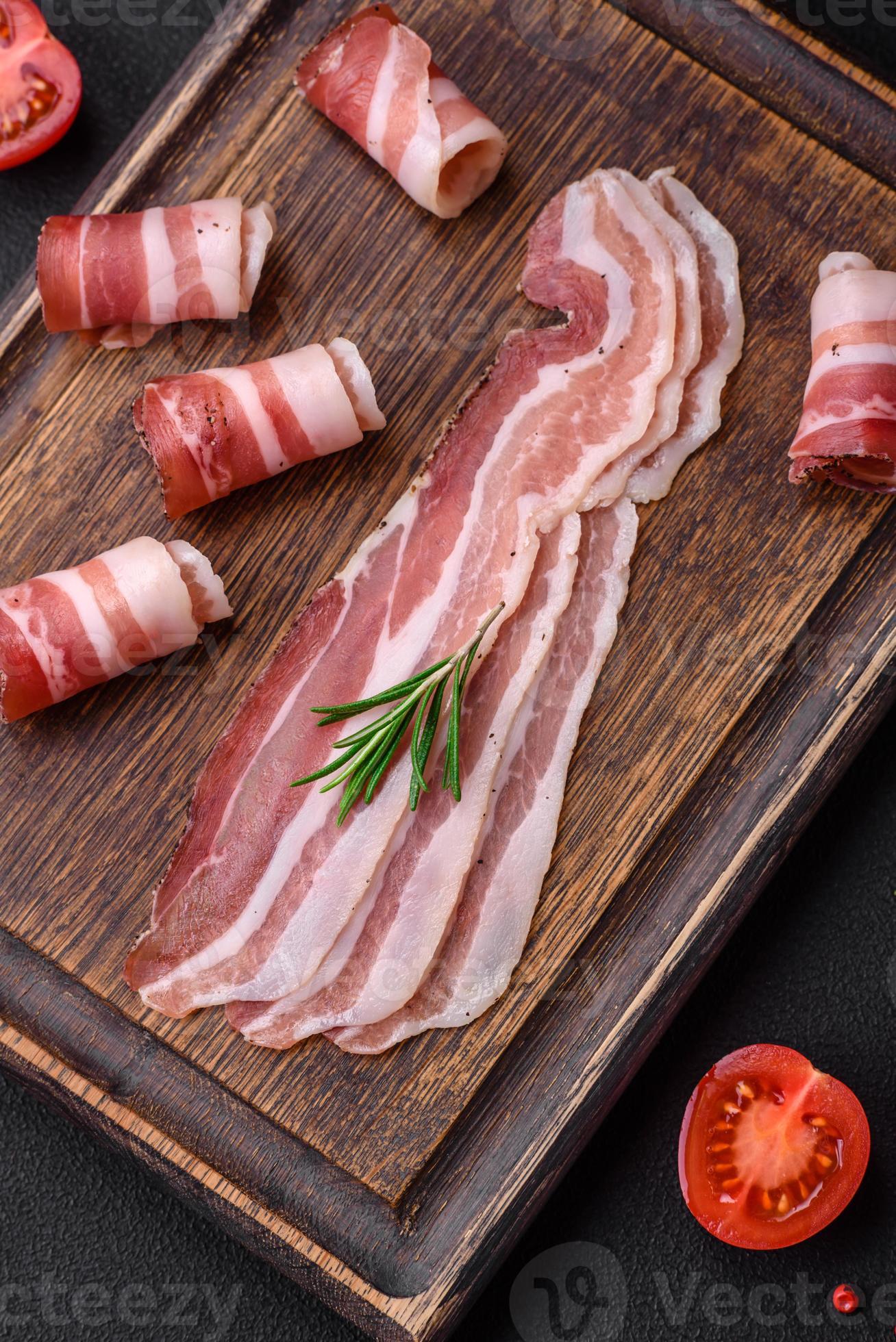 Delicious fresh pancetta with salt and spices cut into thin slices