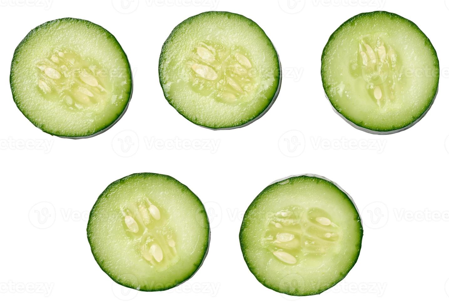 Sliced fresh cucumber on a white background, top view photo