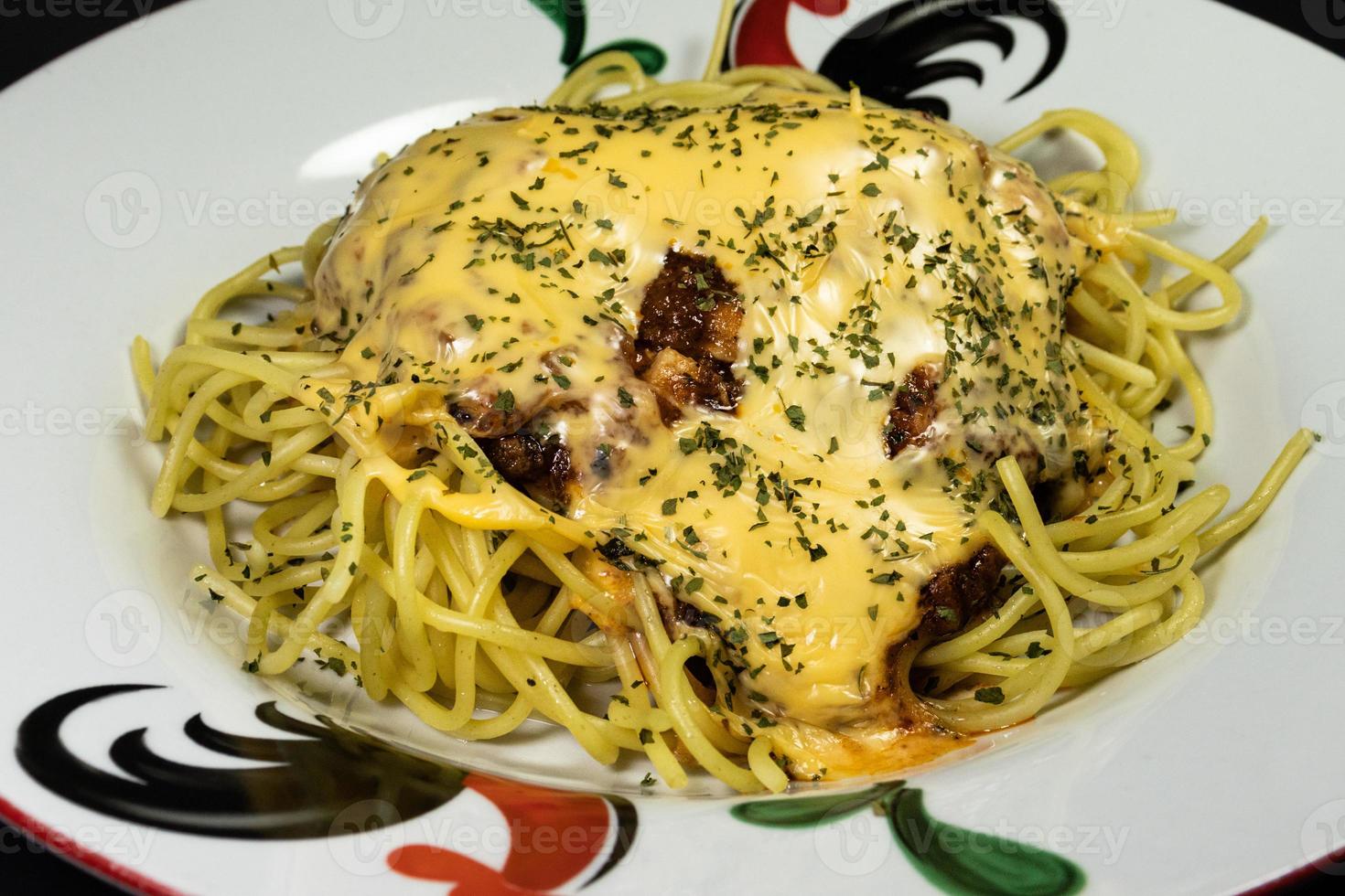 A photo of spaghetti on a chicken patterned plate, after some edits.