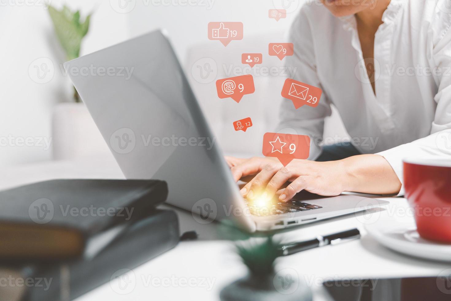 Woman using laptop computer and staying at home for online marketing business. Business woman using smart phone with social network service or SNS, Social media concept. social media business. photo