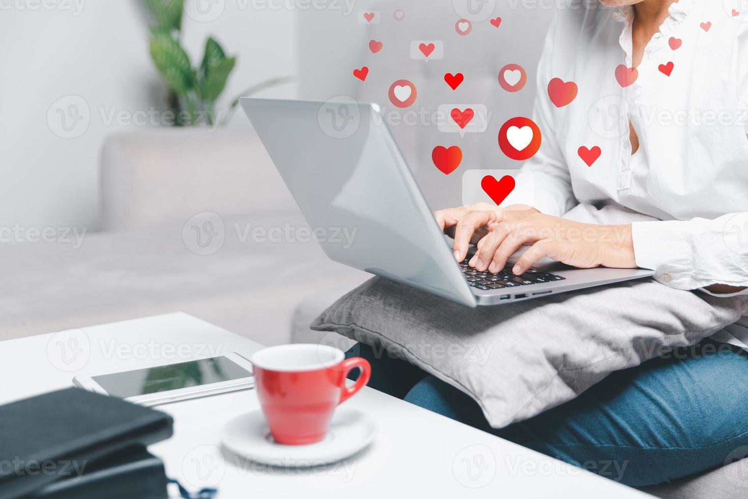 Close up young woman sit on couch at home and using laptop while use online dating application to greeting and talk with other for appointments to flirting for social media lifestyle people concept photo