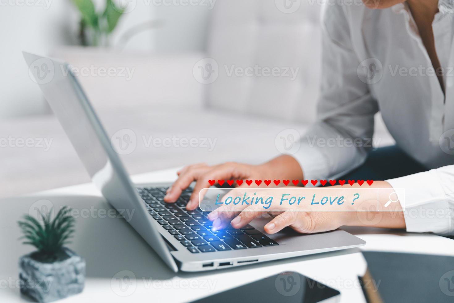 Close up young woman sit on couch at home and using laptop while use online dating application to greeting and talk with other for appointments to flirting for social media lifestyle people concept photo