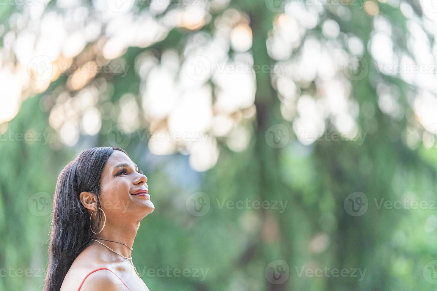 Distracted Transgender happy woman in a park 22567117 Stock Photo