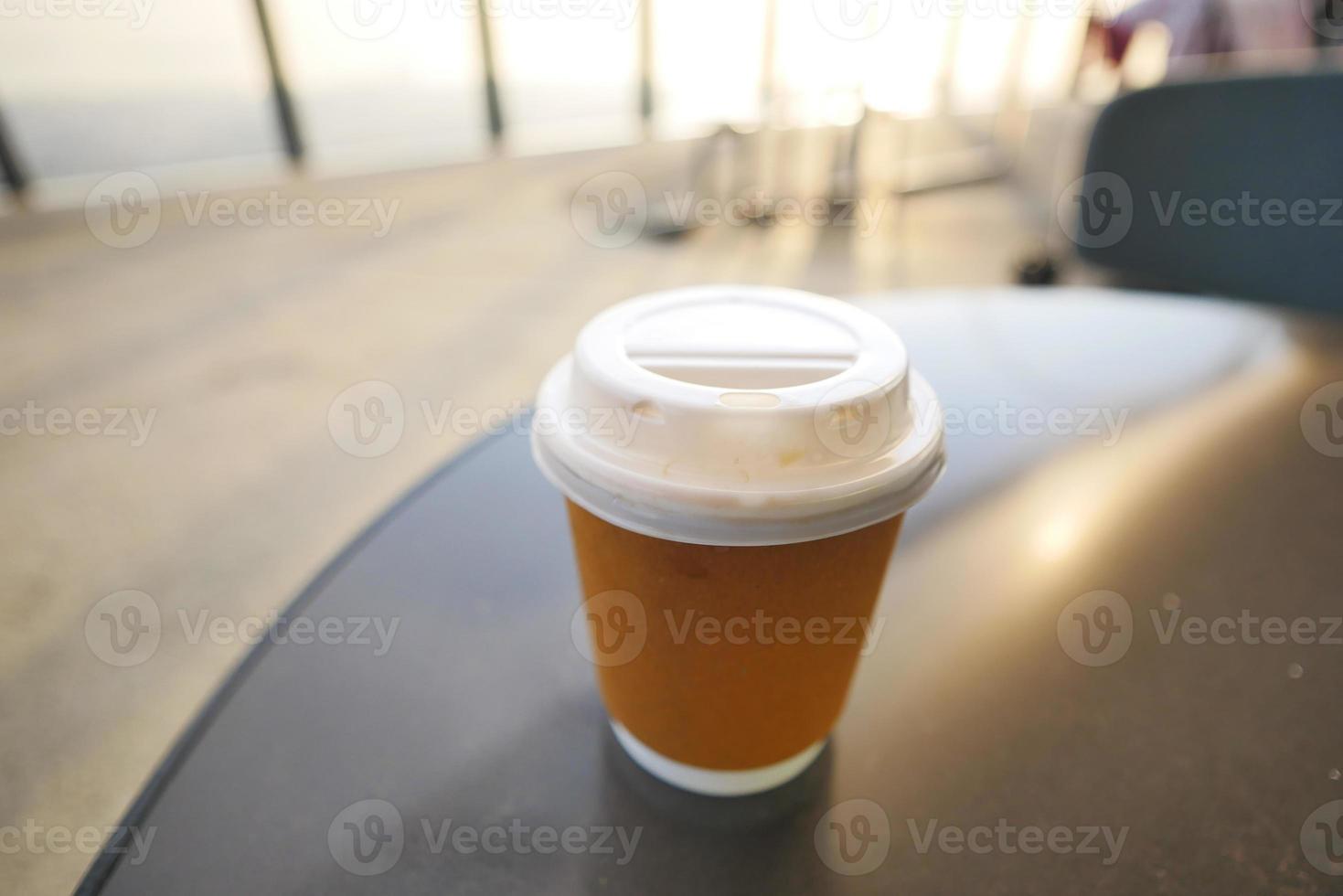 take away paper coffee cup o on cafe table photo