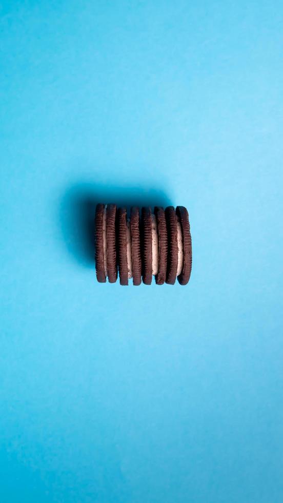 Chocolate cookies on a blue background. Oreo. Top view. Copy space. photo