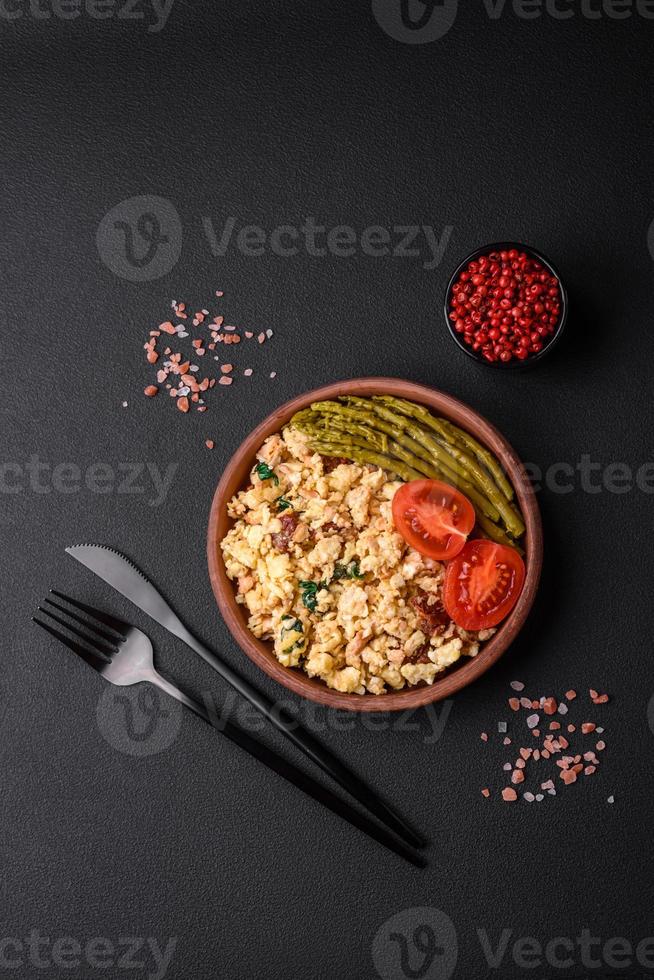 Delicious scramble with salmon, sundried tomatoes, spinach, spices and