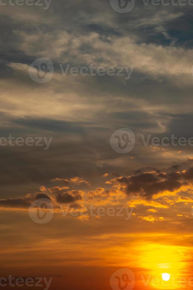 Cover page with deep orange sky, illuminated clouds at bloody sunset as a background. photo