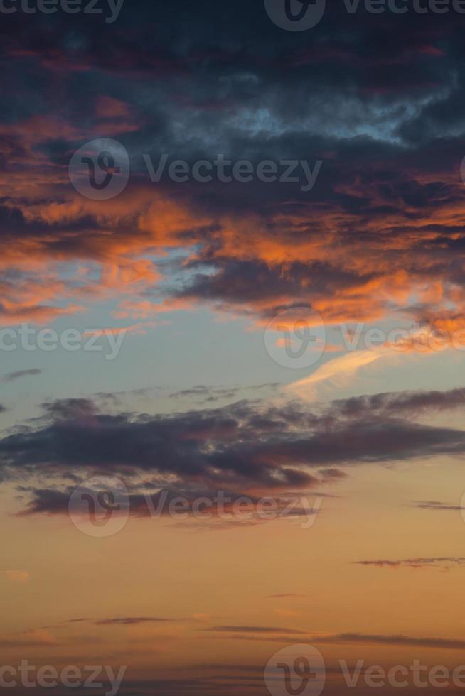 Cover page with gradient soft deep orange sky, illuminated clouds at bloody sunset as a background. photo
