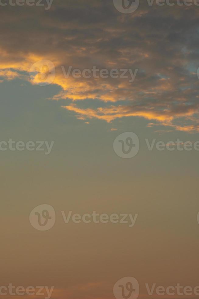 Cover page with gradient soft deep orange sky, illuminated clouds at bloody sunset as a background. photo